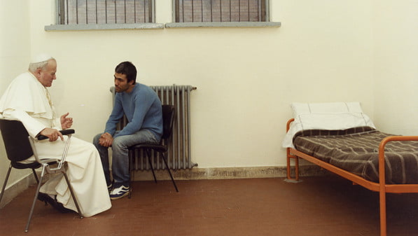 Pope John Paul II sits with his would-be assassin, Mehmet Ali Agca, in Rome's Rebibbia prison in 1983. (CNS photo/Arturo Mari, L'Osservatore Romano)