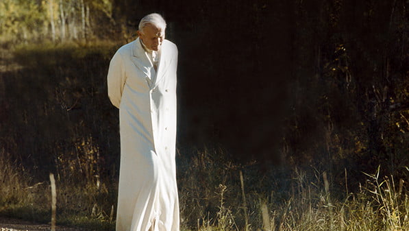 Pope John Paul II walks down a gravel path in an undated photo by Vatican photographer Arturo Mari. (CNS photo/L'Osservatore Romano)